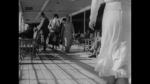 Passengers strolling the deck, ladies sunbathing, crew on watch, UK 1939 Stock Footage 132023123