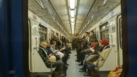 Passengers in the subway sit and read books Stock Footage 125697540
