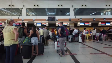 Passengers with suitcases are queuing up for check-in. Stock Footage 166487918