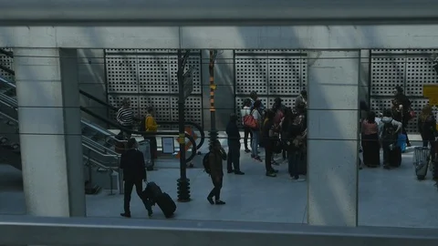 Passengers with suitcases out of the train to the platform of the train station Stock Footage 105873282