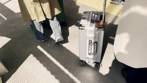 Passengers with suitcases standing in line at a train station platform Stock Footage 343550255