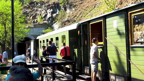 Passengers taking short rest in front of the train in Mokra Gora. Video stock 162691883