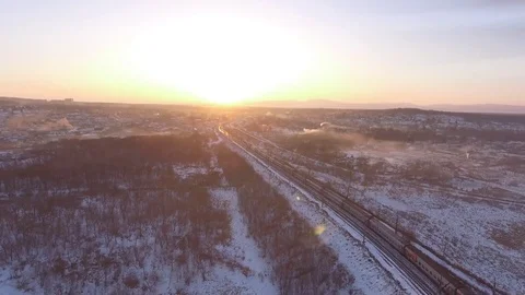 Passengers train goes winter environment. Snow field aerial 4k behind the train  Stock Footage 74503291
