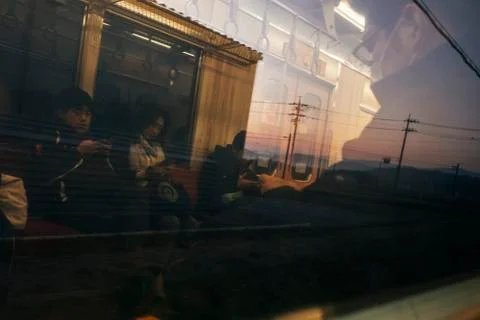 Passengers on the train reflected on the window Stock Photos