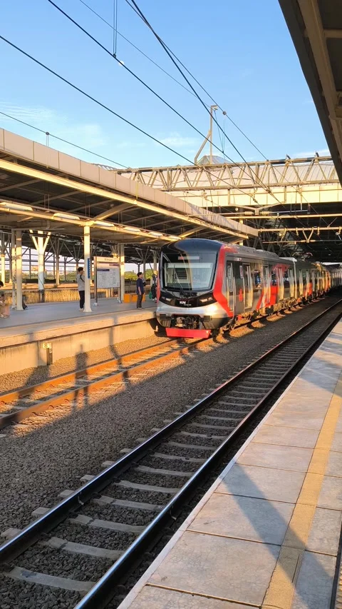 Passengers on the train station platform waiting for the train to arrive Stock Footage 319541121