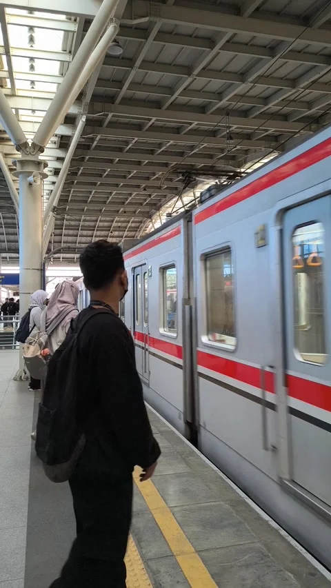 Passengers on the train station platform waiting for the train to arrive Stock Footage 319541130