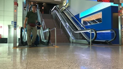 Passengers in transit descend from the escalator. Stock Footage 94140206