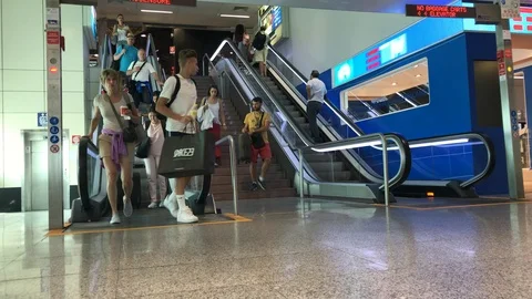 Passengers in transit descend from the escalator. Stock Footage 94140292