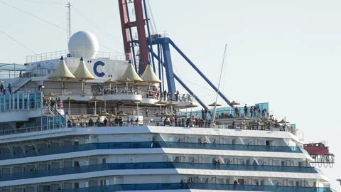 Passengers on upper decks of Costa cruise ship departing port close up Video stock 340402551