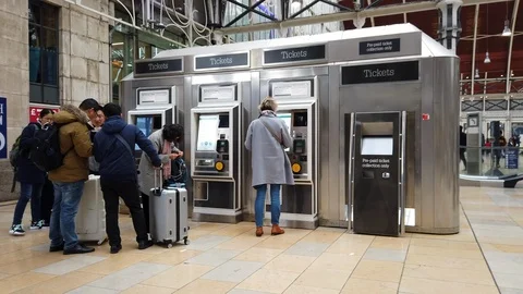Passengers use self service train ticket machines at Paddington Station, London Stock Footage 104013487