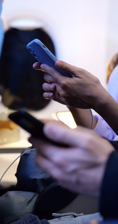 Passengers using smartphones on airplane, close up view with blurred background Stock Footage 303991777