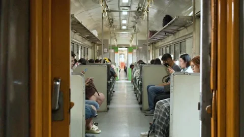 Passengers Using Smartphones Inside Moving Bangkok Commuter Train Carriage Stockbeeldmateriaal 323339532