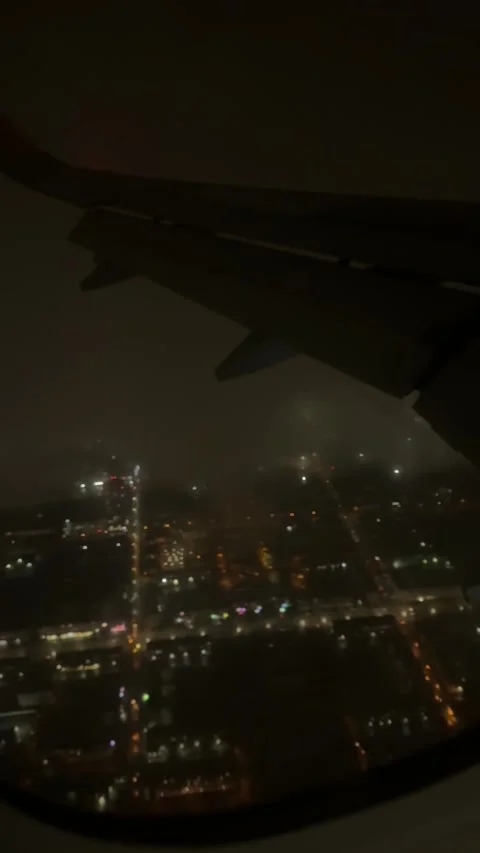 Passenger's view from airplane window during night landing over a city with l Stock Footage 321764115