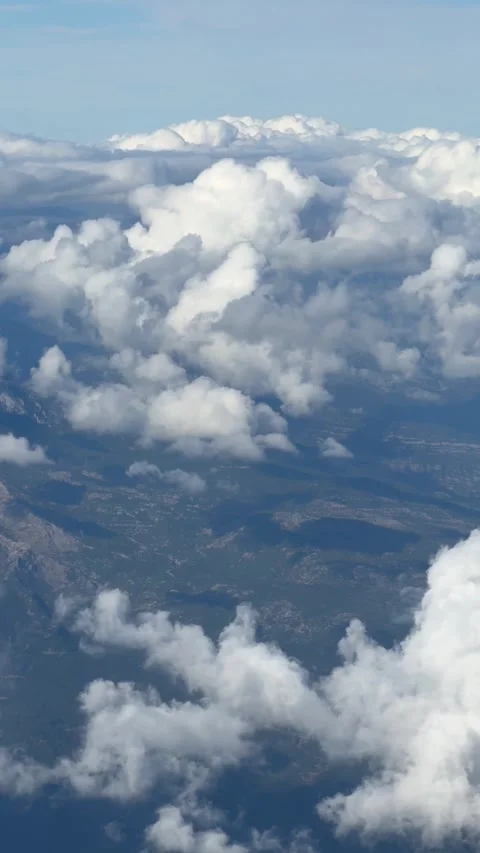 Passengers view from airplane window flying high above forest-covered mountai Stock Footage 325649277