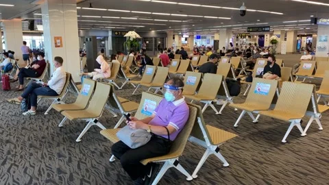 Passengers wait for a flight in the gates area of Phuket airport, Thailand 4K Stock Footage 196550061