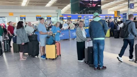 Passengers wait in Heathrow Terminal 5 as flight chaos continues  Stock Footage 345028760