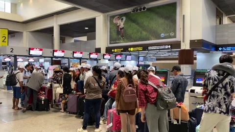 Passengers wait in line for check in, Don Mueang airport, Bangkok, Thailand 4K Stock Footage 283750654