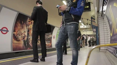 Passengers wait on London Underground platform at Leicester Square as train arr Vidéo 65211965