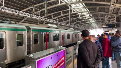 Passengers wait for a metro rail train at a station in Dhaka, Bangladesh Stock Footage 345541913