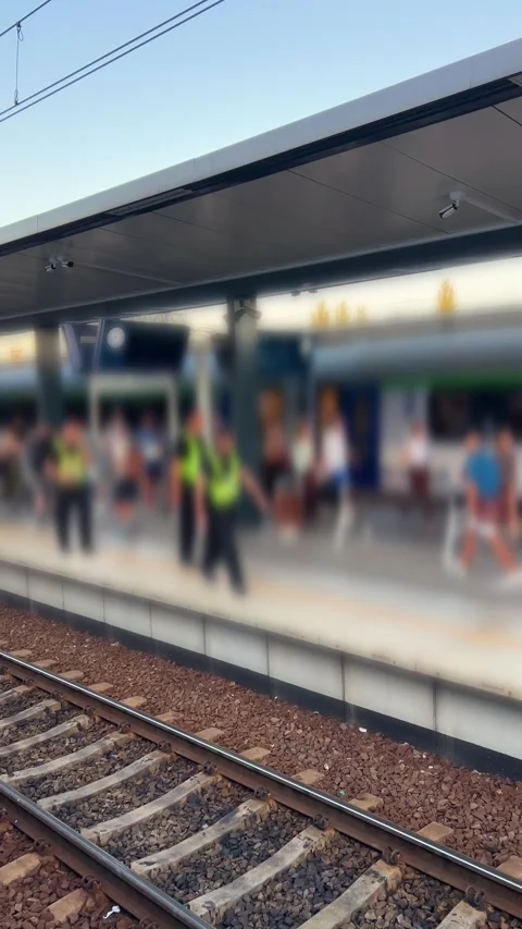 Passengers wait on the platform next to an intercity train at Lublin Glowny Stock Footage 346368794