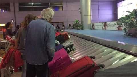 Passengers wait for their luggage Stock Footage 62829384