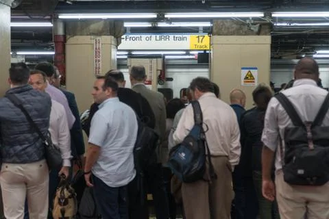 Passengers wait of track platform in Penn Station Фото