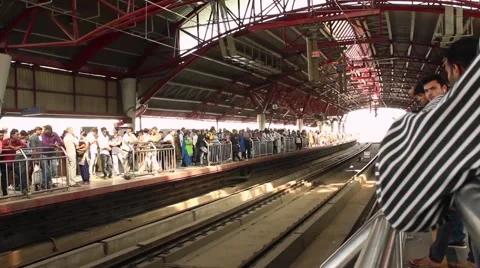 Passengers wait for the train to arrive in the New Delhi metro system. Stock Footage 58599945