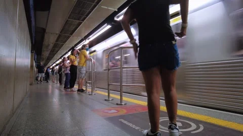 Passengers wait for the train to arrive on the platform of blue line 1 of subway Stockbeeldmateriaal 252164748