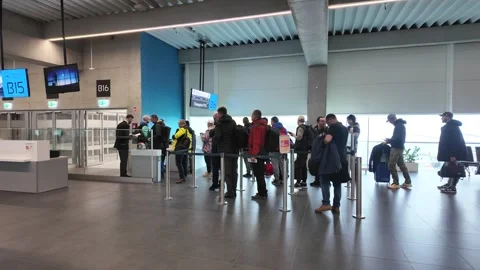 Passengers Waiting in Airport Boarding Queue at Modern Gate B16 with Luggag.. Stock Footage 340166309