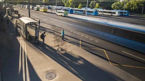 Passengers waiting and boarding buses at the bus terminal, time lapse Stock Footage 111817403