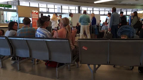 Passengers waiting by the boarding gate ready to board their flight. 스톡 동영상 244844901