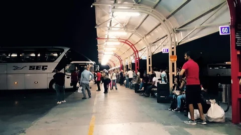 Passengers waiting the bus at Bursa Bus Terminal at night Stock Footage 104490910