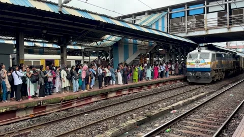 Passengers waiting on the platform as a train from Indian Railways arrives Stock Footage 341455704