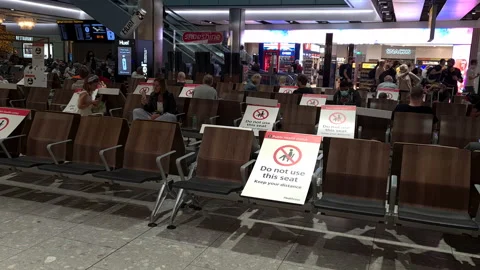 Passengers waiting for their flight in Heathrow airport. Stock Footage 158672230