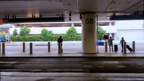 Passengers waiting for their ride in the arrival terminal at LAX airport Stock Footage 220032962