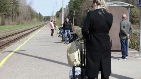 Passengers waiting for the train standing on the platform. Stock Footage 188844774