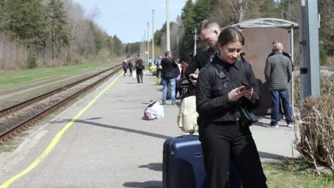 Passengers waiting for the train standing on the platform. Stock Footage 188845126