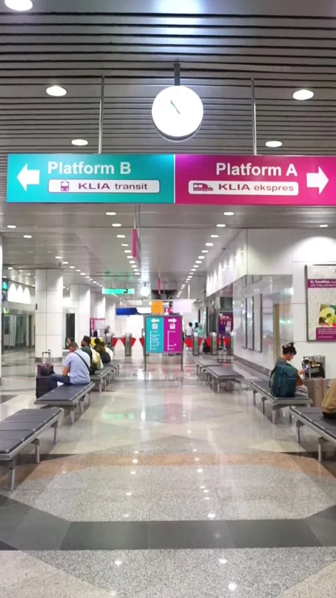 Passengers waiting in the underground concourse of the KLIA Express station. Stock Footage 320145908
