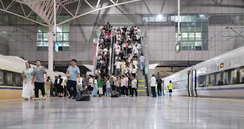 Passengers walk down staircase to high speed train platform at Shanghai Stock Footage 327652508