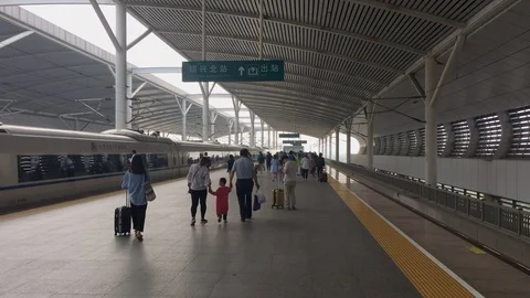 Passengers walk off the high-speed train to the platform exit 스톡 동영상 125221083