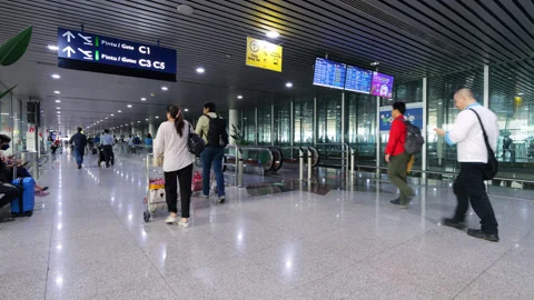 Passengers walk inside corridor of Kuala Lumpur International Airport terminal Stock Footage 319012401