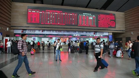 Passengers walk inside of a train rail station in Beijing, China Stock Footage 71473487
