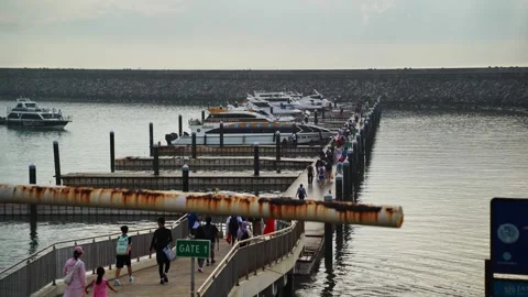 Passengers walking along the pier toward speedboats at a harbo (August, 2026) Stock Footage 344139208