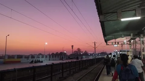 Passengers Walking Along Railway Platform at Sunset in India Stock Footage 323864837