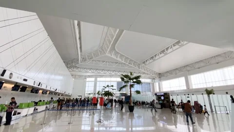 Passengers walking and queuing at check in counter in Ahmad Yani Airport Stock Footage 333235872