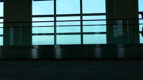 Passengers walking inside the air terminal Stock Footage 75985865