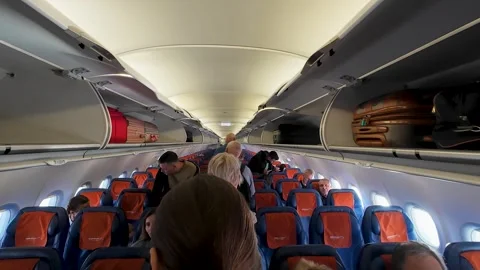 Passengers walking inside airplane cabin Stock Footage 316552388