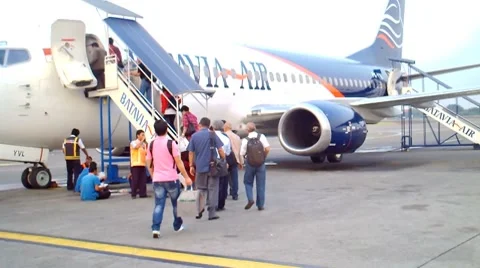 Passengers walking to the plane Stock Footage 8659247