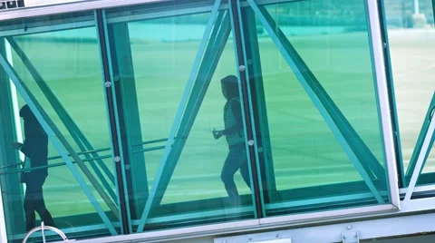 Passengers walking through the docking sleeve to their waiting aircraft Stock Footage 54903774