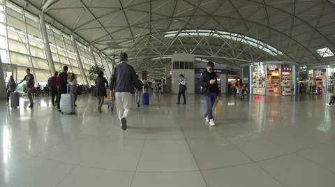 Passengers walking through frame inside Incheon Airport Stock Footage 34145232